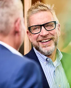 Candid photograph of colleagues laughing at a corporate event